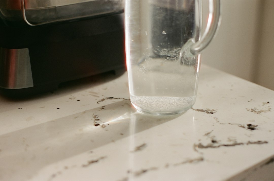 Clear glass pitcher with water on a countertop