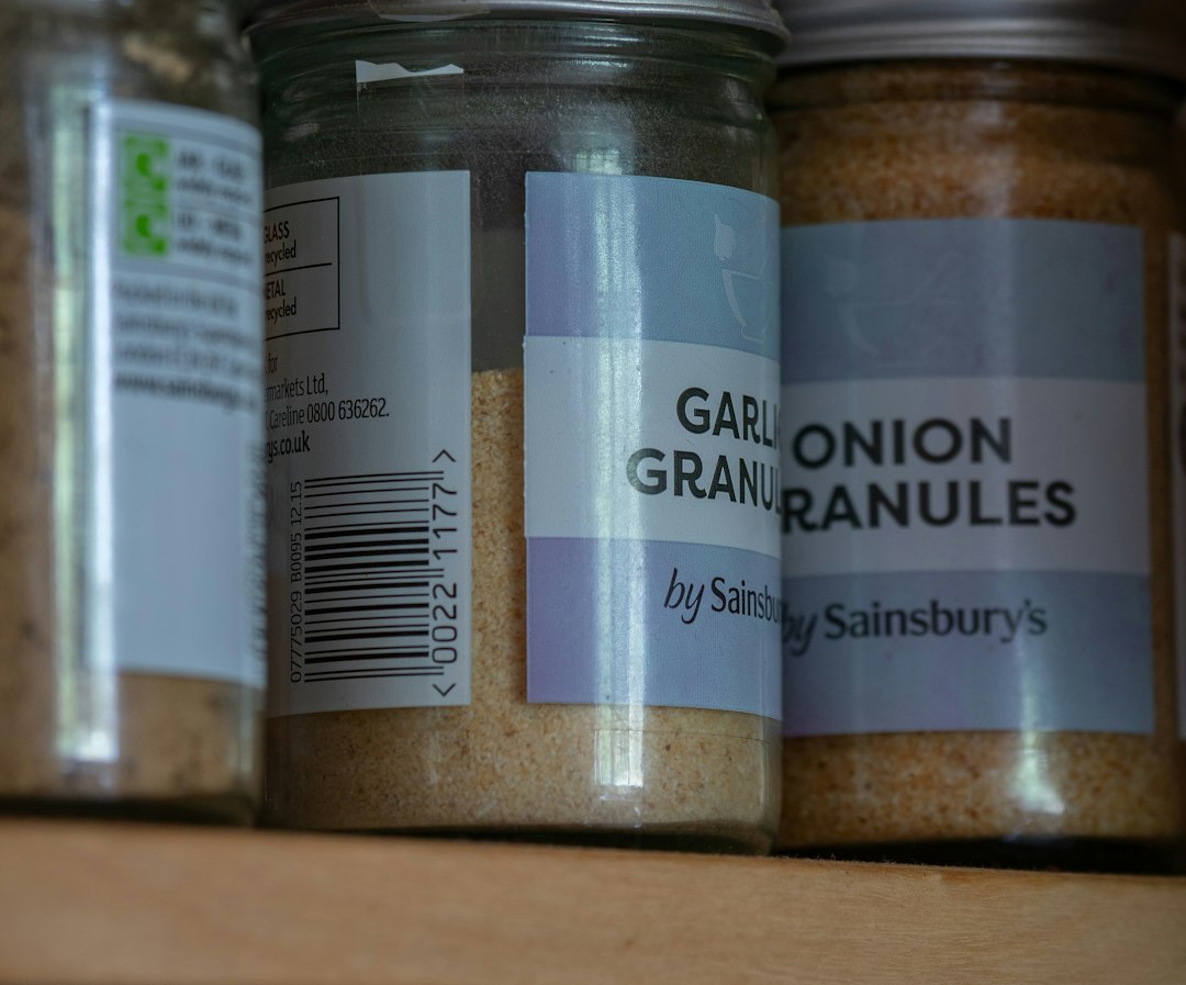 Glass jars of garlic and onion granules on a shelf