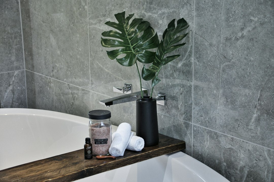 white ceramic bathtub with soap bottles