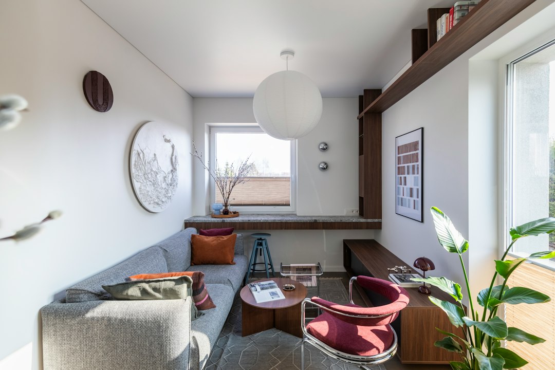 Cozy modern living space with sofa, armchair, and natural light